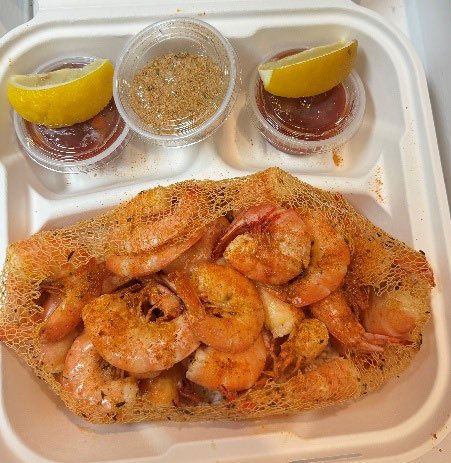 Steamed spiced shrimp with cocktail sauce and lemon